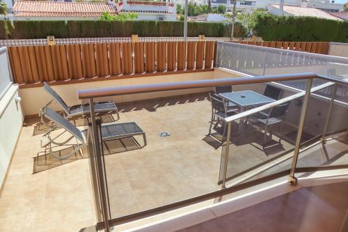 a patio with a table and chairs on a balcony at Albir Palace in Albir