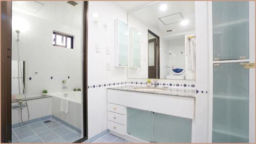 a bathroom with a sink and a tub and a shower at Saigon Sky Garden Serviced Apartments in Ho Chi Minh City