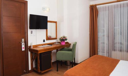 a hotel room with a desk and a mirror at A Diamond The Resort Spa Sapanca in Sapanca