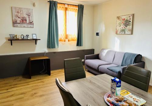a living room with a couch and a table at Assisi, Angolo di Matilde in Petrignano