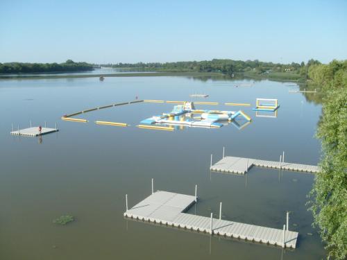an aerial view of a lake with a dock and boats at Tisza-tó Apartmanpark in Kisköre