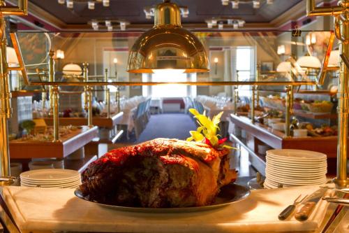 a large turkey sitting on a table in a restaurant at Kviknes Hotel in Balestrand