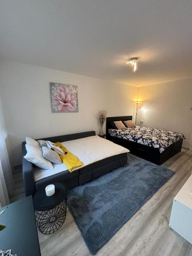 a bedroom with two beds and a rug at Studio apartman Stefi in Samobor
