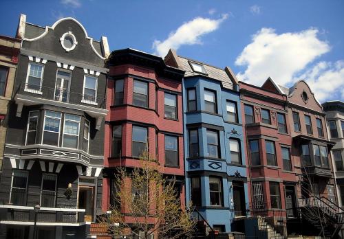 a group of buildings in front of a blue sky at Men House JFK Airport in Brooklyn Manor