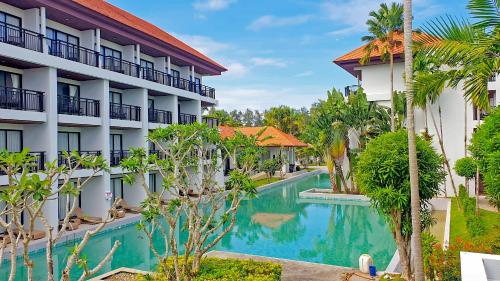 a view of the courtyard of a hotel with a swimming pool at Estella Phuket Mai Khao Beach Resort in Mai Khao Beach