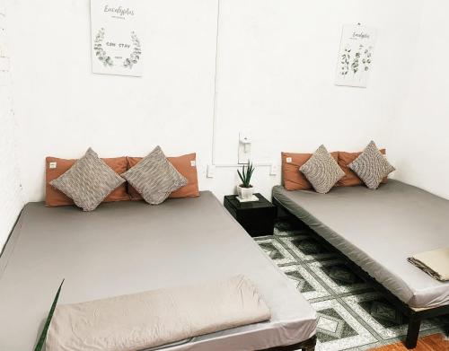 two beds sitting in a room at Samstay in Tuy Hoa