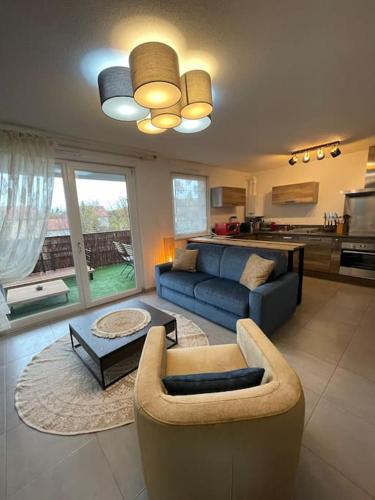 un salon avec un canapé et une table dans l'établissement Appartement - Note Boisée - Terrasse & Parking, à Sélestat