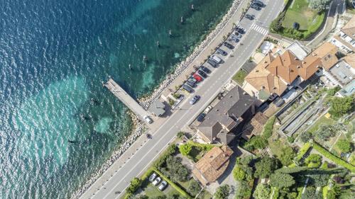 an aerial view of a road next to the water at Lake Sensation - Garda Lake View in Nago-Torbole