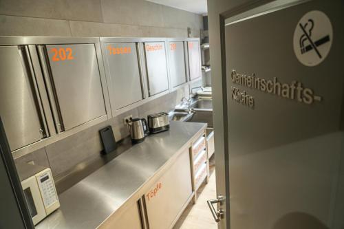 a kitchen with a stainless steel counter and appliances at Aparthotel Rotheul 