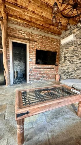 a table in a room with a brick wall at Black Rock Agria in Agria