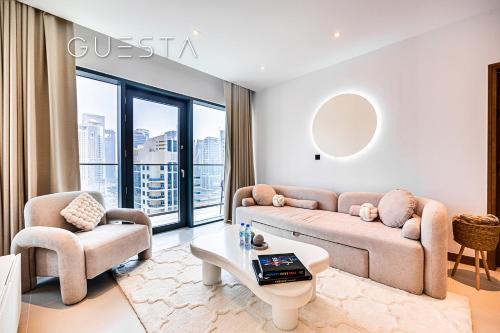 a living room with a couch and two chairs and a table at Vida Residences Dubai Marina by Emaar in Dubai