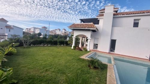 a house with a yard and a swimming pool at villa star hill Tanger in Tangier