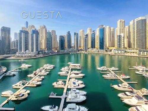 a group of boats docked in a harbor with a city at Vida Residences Dubai Marina by Emaar in Dubai