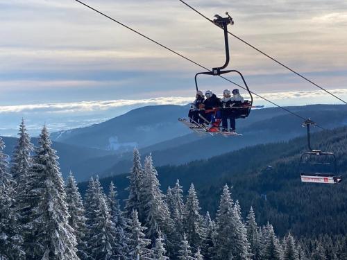 a group of people riding on a ski lift at Apartmán Mlýn Herlíkovice 205 in Vrchlabí