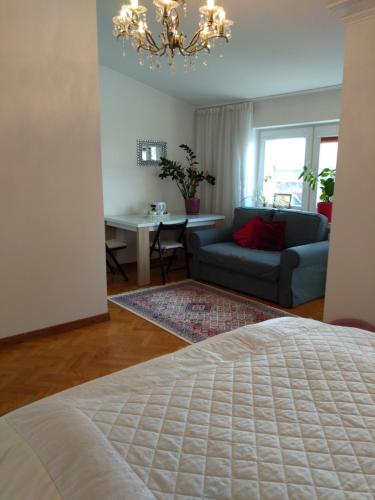 um quarto com uma cama, um sofá e uma mesa em A cosy private room in the heart of old Podgorze em Cracóvia