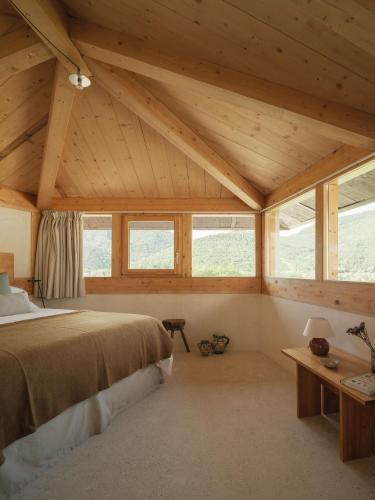 a bedroom with a bed in a room with windows at El Priorato de Trespaderne in Trespaderne