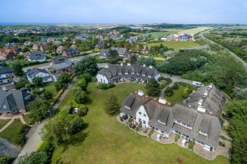 an aerial view of a large house in a village at Ameland App 12 in Wenningstedt