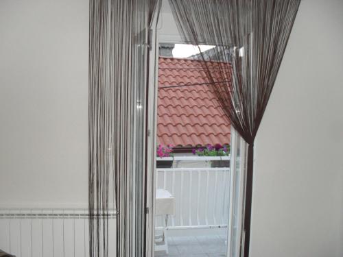 a mirror in a room with a view of a window at Rooms Natalija in Sveti Juraj