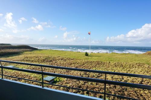 a view of the ocean from the balcony of a house at Seafront Duenenhof zum Kronprinzen in Wenningstedt