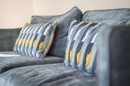 a couch with two pillows on top of it at Lille Wung in Wenningstedt