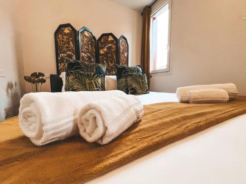 a bedroom with two beds with towels on it at LE MURANO LUXURY LAGOON in Murano