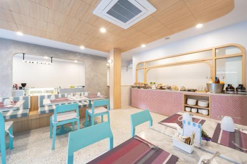 a restaurant with tables and chairs and a counter at The Verandah - SHA Extra Plus in Ao Nang Beach