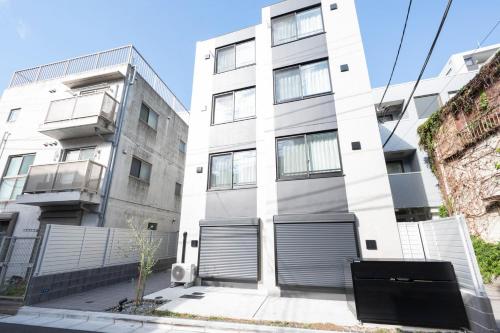 an apartment building with two garage doors at FL Residence Jingu Gyoen IV in Tokyo