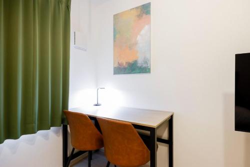 a table and two chairs in a room at FL Residence Jingu Gyoen IV in Tokyo