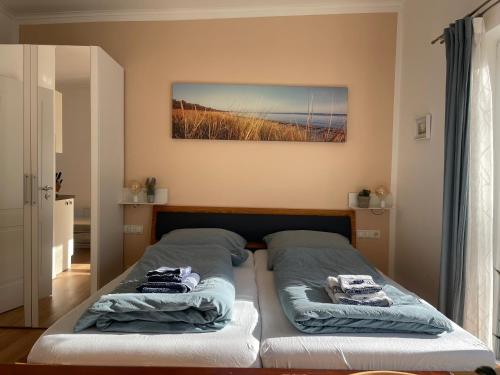 a bedroom with a bed with towels on it at Klein aber Fein mitten in Binz in Binz