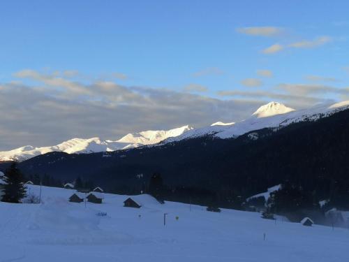 a snow covered mountain range with snow covered mountains at Appartamenti dolomitici in Padola