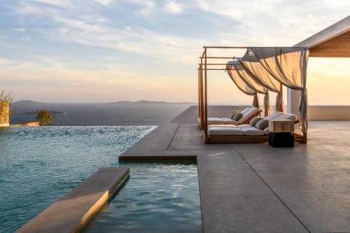 a luxury villa with a bed and a pool at Silver Breeze Villa in Mýkonos City