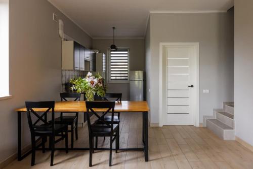 a kitchen and dining room with a table and chairs at Таун Тераса 2 поверхи by Willox in Chernivtsi