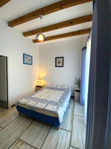 a bedroom with a bed and a television in it at Appartement en rez de villa in Aregno