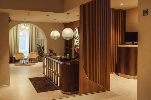 a lobby with a reception desk and a living room at Konventa Sēta Hotel Keystone Collection in Riga