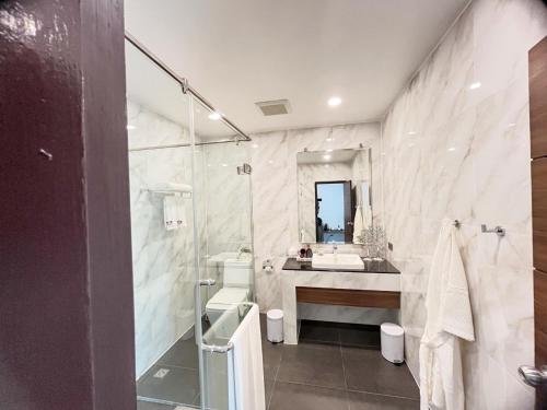 a bathroom with a sink and a toilet and a mirror at Pearl Andaman Resort Ranong Koh Koo 