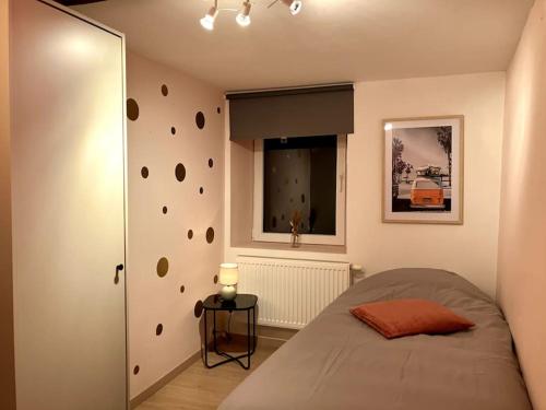 a bedroom with a bed and a rock wall at Chez Koulla et Romu in Durbuy