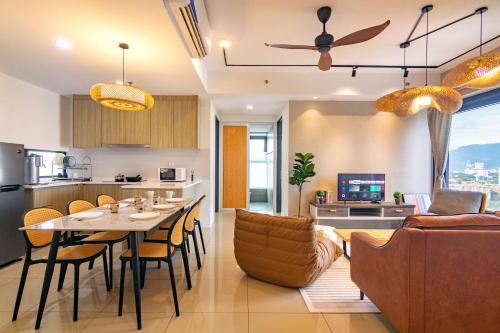 a kitchen and living room with a table and chairs at ❈ Tropicana 218 by ALV Suites ❈ in George Town
