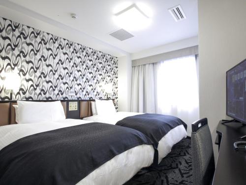 Llit o llits en una habitació de APA Hotel Akita-Senshukoen