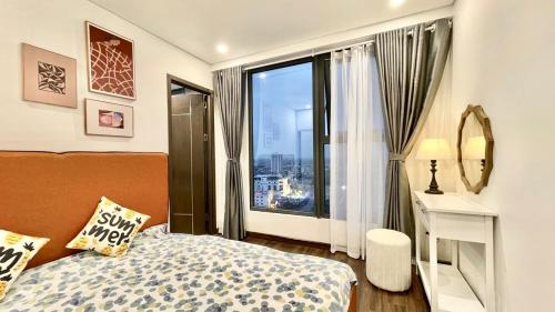 a bedroom with a bed and a large window at Căn Hộ Cao Cấp 2 Ngủ Grand Tower in Hai Phong