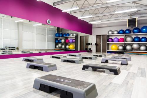 a gymnasium with a row of exercise mats at Mirax Boutique Hotel in Kharkiv