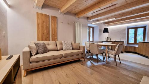a living room with a couch and a table at Alpine Chic Retreat in Courmayeur