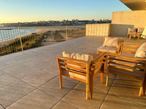 a patio with two chairs and a table on a balcony at Porto Sunset flat in Vila Nova de Gaia
