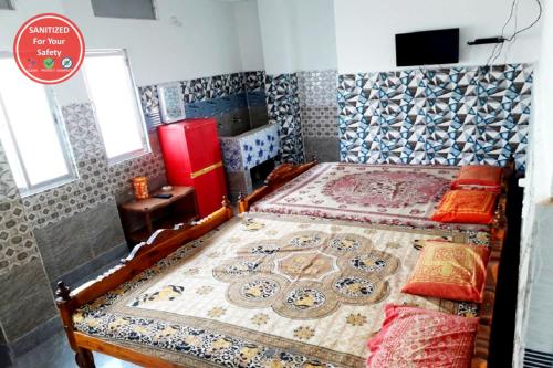 a bedroom with a large bed with a moroccan themed bedspread at Goroomgo Pranab Sadan Puri in Puri