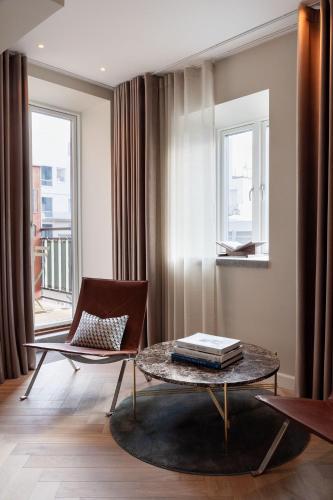 a living room with a table and a chair at Ascot Hotel in Copenhagen