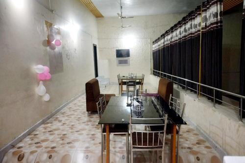 a dining room with tables and chairs and pink balloons at Hotel Kumkum Chhaya in Panna