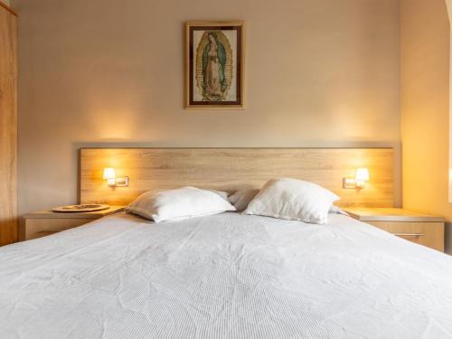 a bedroom with a large white bed with two pillows at Holiday Home Villa Jardin by Interhome in Vilafortuny