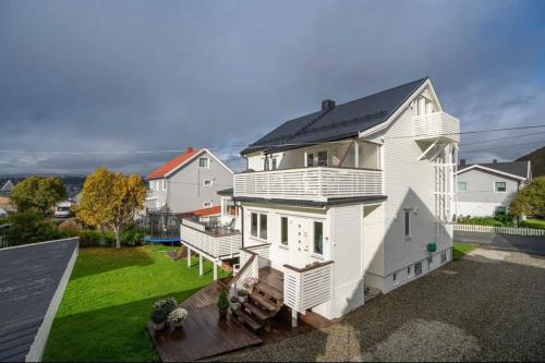 a white house with a black roof at Tromsø’s best location? City & Nature 5 mins away. in Tromsø