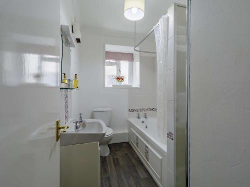 a white bathroom with a sink and a toilet at 1 Bed in Keswick 86395 in Rosthwaite