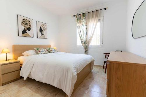 a white bedroom with a bed and a window at rentafive - Nuevo - A/A - Barbacoa - Tenis in Santa Pola