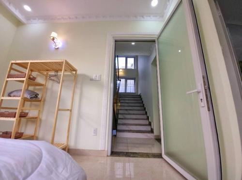 a bedroom with a staircase and a room with a bed at Big villa, new, near center in Ho Chi Minh City